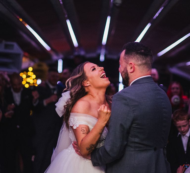 Bride and groom have their first dance in the secret basement disco club area at St Giles House 