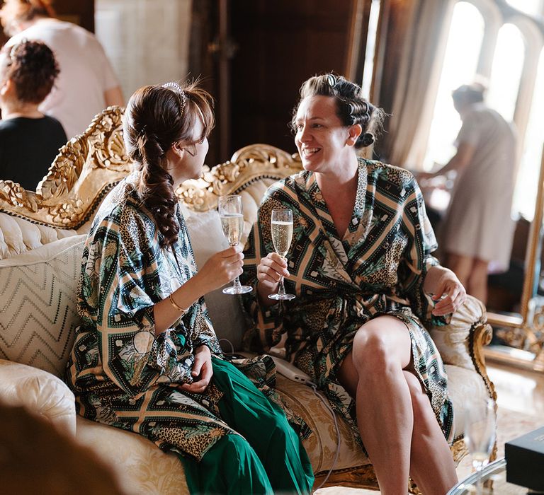 Bridal party in patterned robes getting ready together for the wedding day 