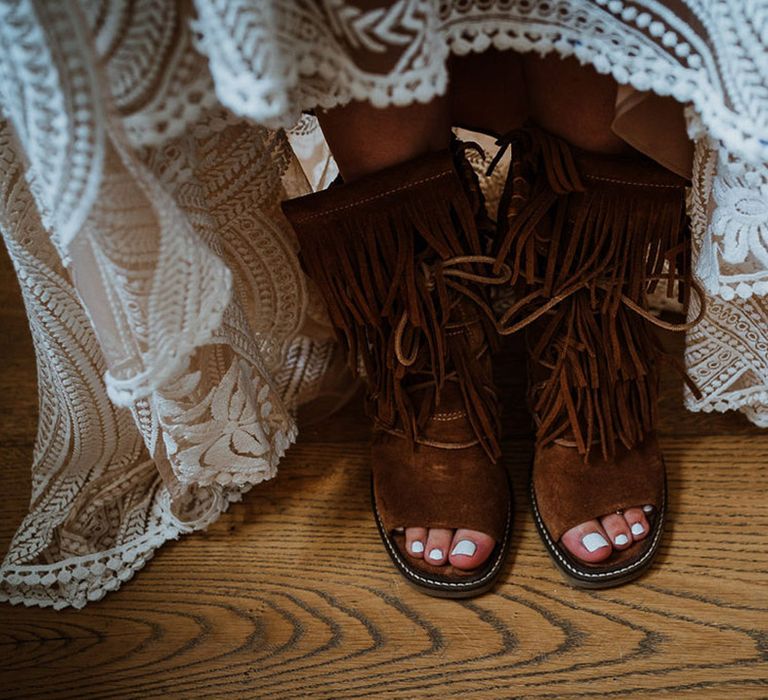 Bride wearing brown suede tassel boots  