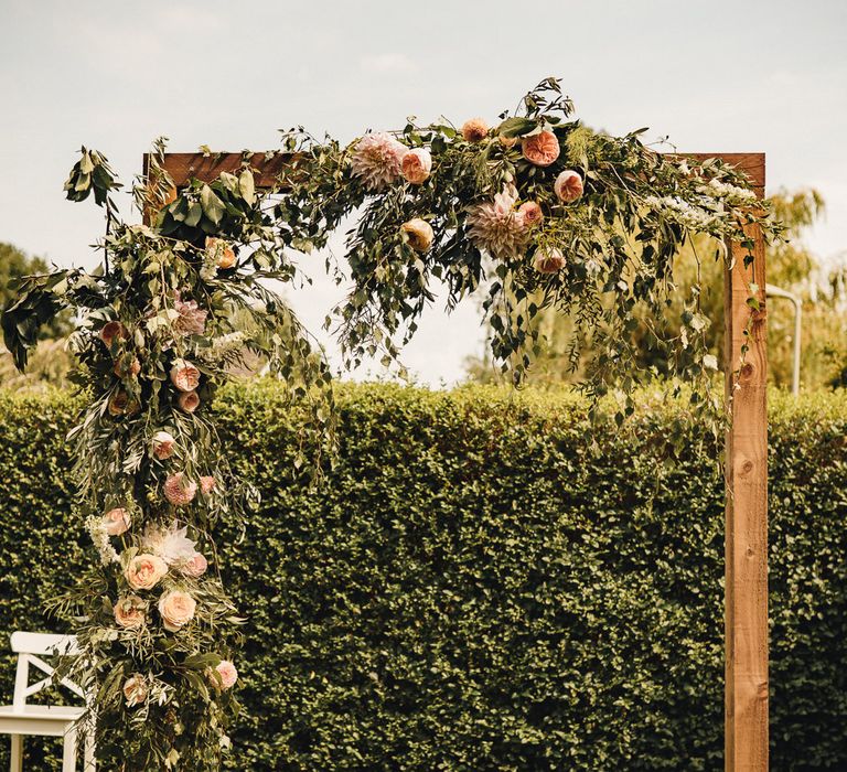 Wooden framed altar and wedding flowers at outdoor intimate wedding 