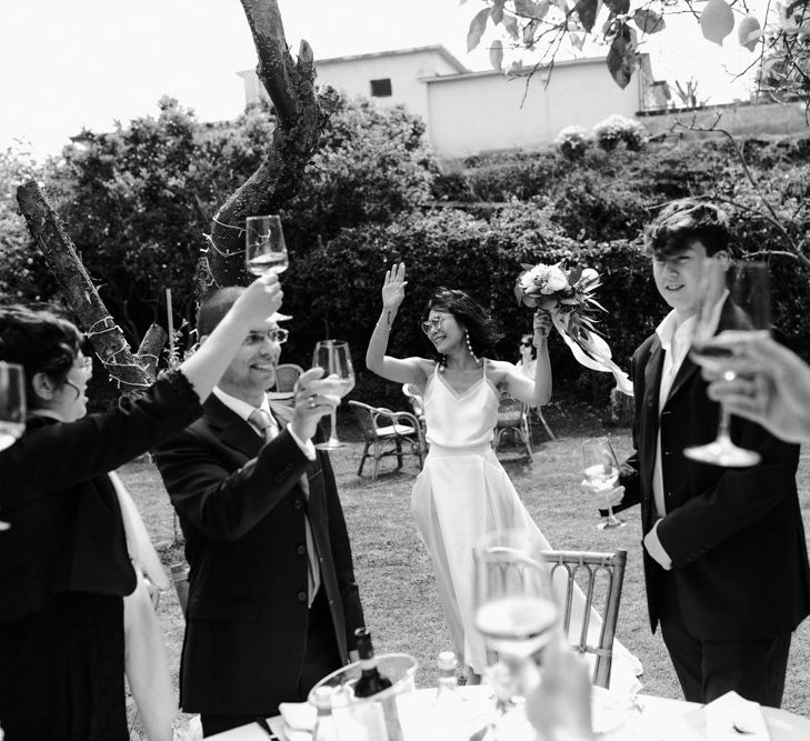 Bride entering the outdoor wedding reception in a Halfpenny London skirt 