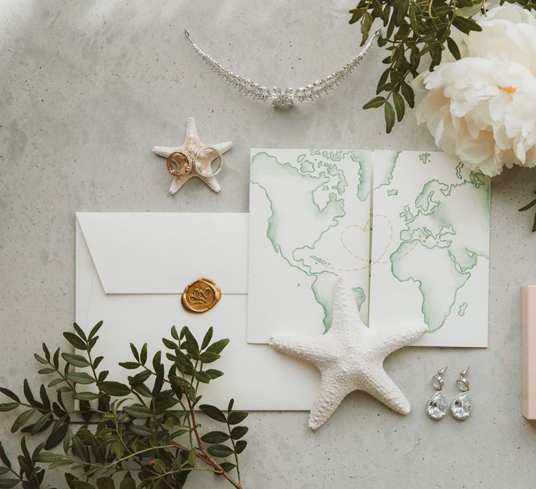 Green map wedding invitation with perfume and accessories 