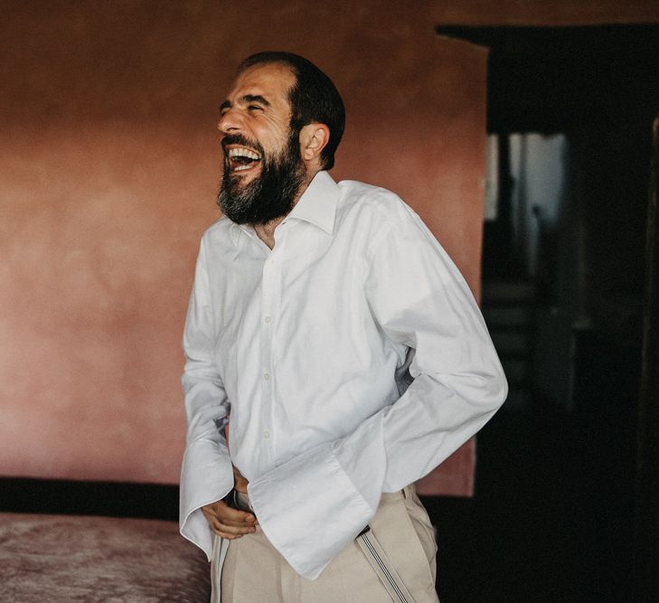 Groom laughing in Suter & Co suit