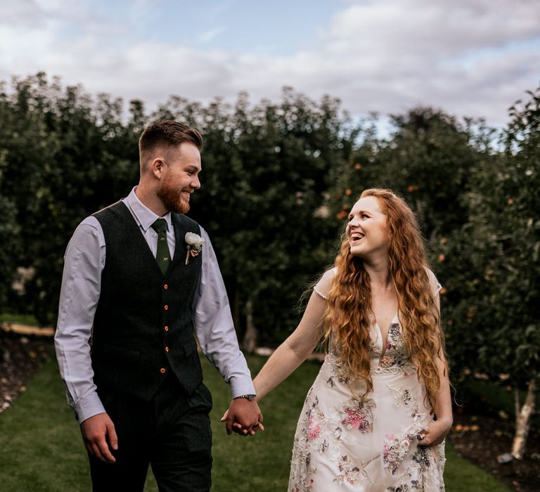 Bride & groom walking through Houghton Lodge Gardens