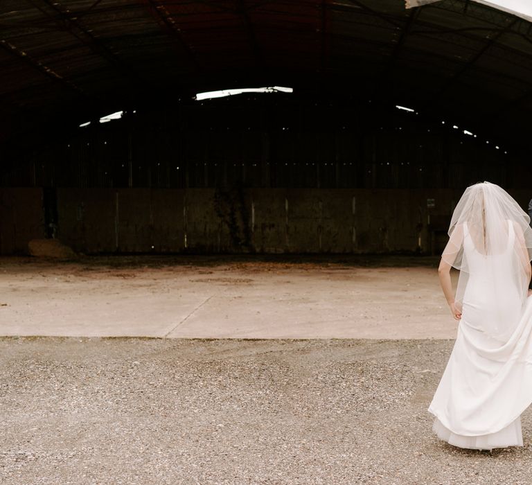 Bride and groom portraits in the sheds at Clock Barn wedding venue