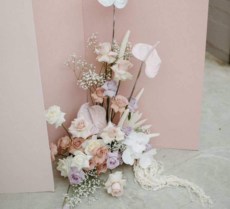 Tall wedding flower arrangement with anthuriums and roses 