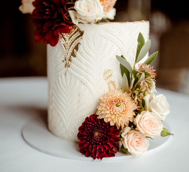 Autumnal wedding cake with pink red and white flowers