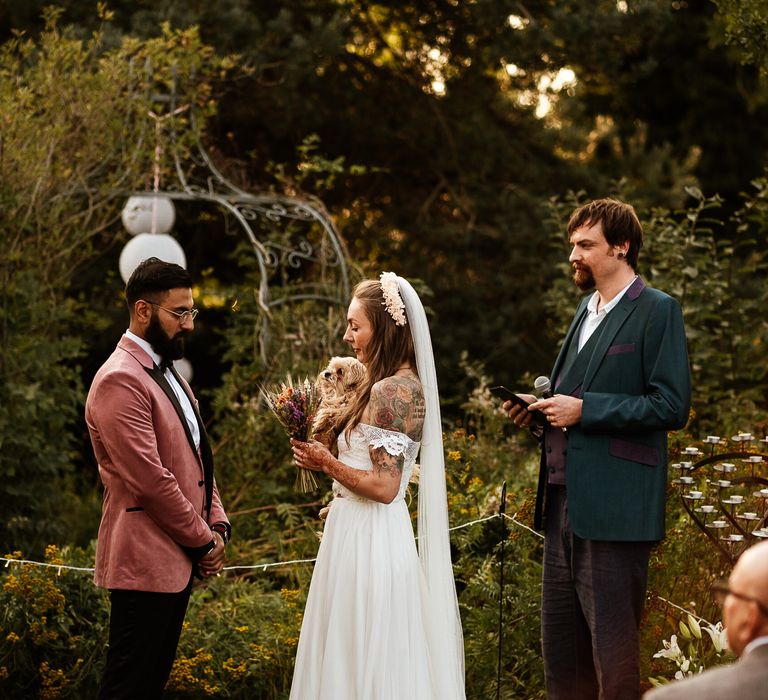 Bride & groom during wedding ceremony outdoors in the garden