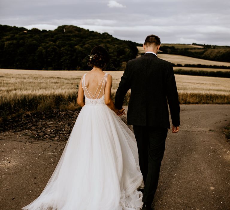 Cascading tulle princess wedding dress with strap back detailing by Chloe Mary Photo