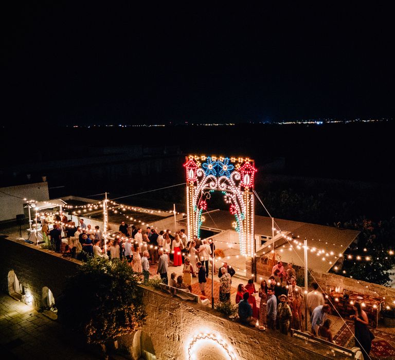 Pre-wedding party celebrations with festoon lighting on the rooftop at Masseria Potenti