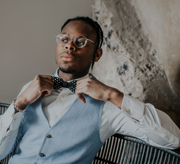 Stylish groom with black metal bow tie 