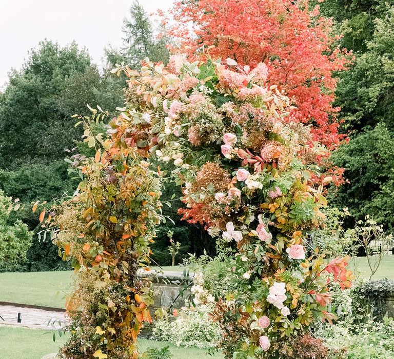 Autumn flower arch at Dorfold Hall outdoor ceremony 