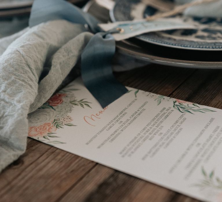 Pale grey plates with pale blue napkins tied with brown string