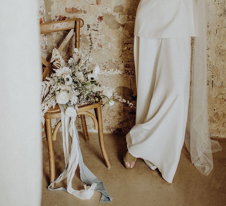 Bride in a double breasted blazer and wide leg trouser suit and long veil at bohemian luxe wedding 