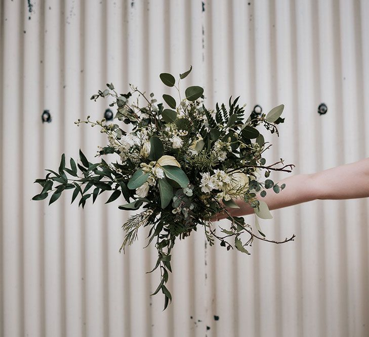 Oversized green foliage and white flower wedding bouquet with roses and eucalyptus 