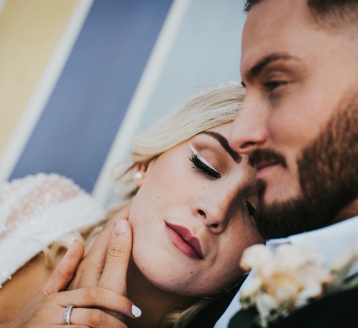 Bridal makeup up with white winged eyeliner and nail polish and deep red lipstick 