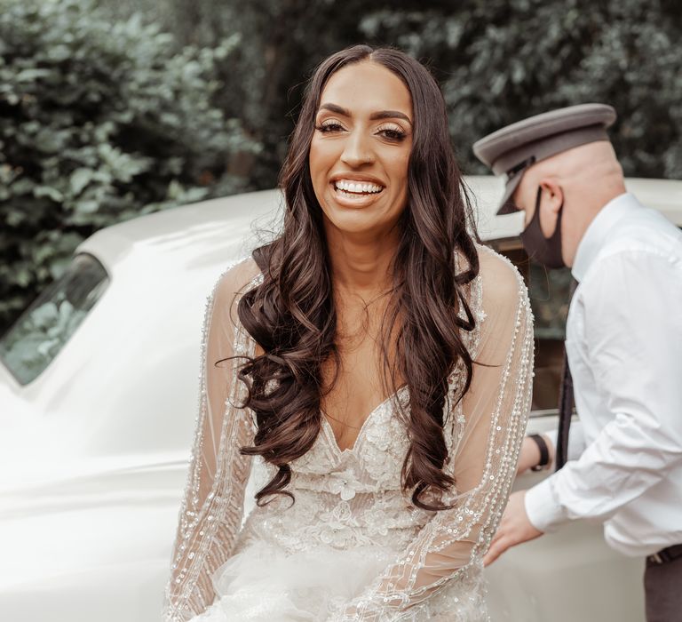 Bride leaves wedding car as she walks toward ceremony on her wedding day