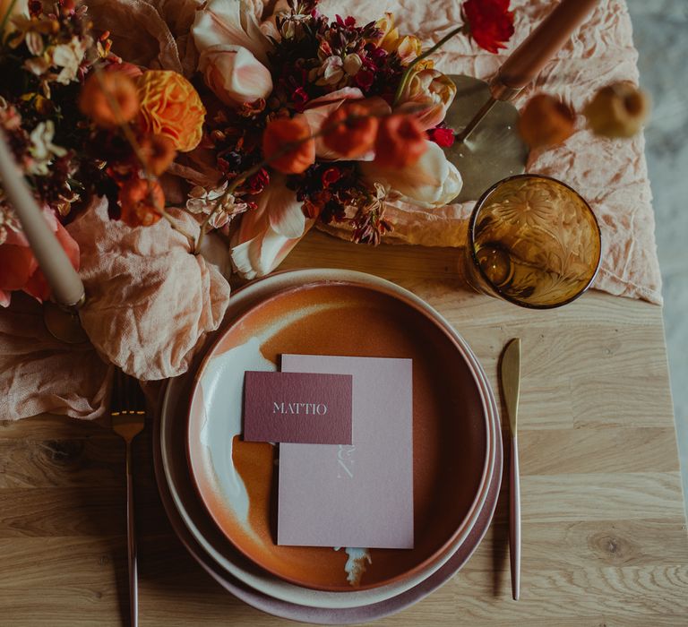 Wedding place setting with beautiful florals and romantic candles