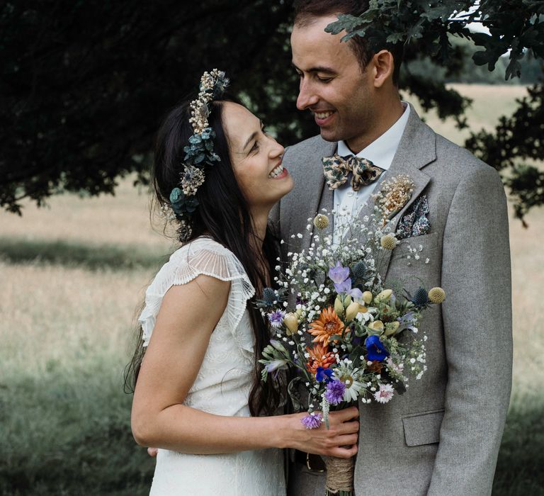 Bride leans into groom as he looks lovingly at her on their wedding day