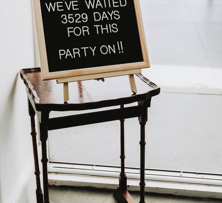 Personalised sign board set on easel on a wooden table