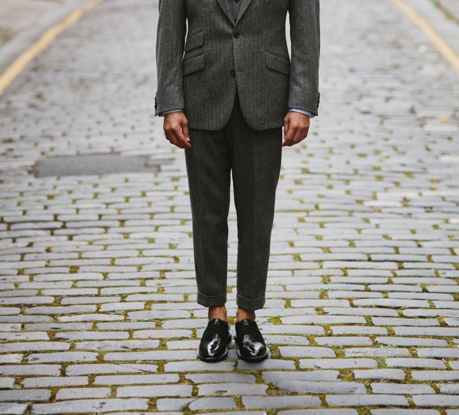 Groom in a charcoal grey pinstripe wedding suit 