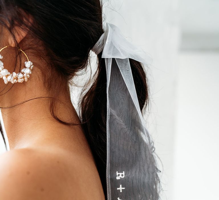 Personalised veil bow hair accessory embroidered with the couples initials and wedding date 