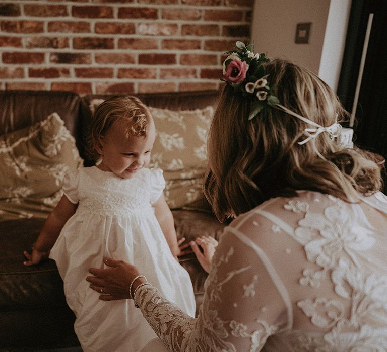 Cute flower girl in a Monsoon dress with lace detail 