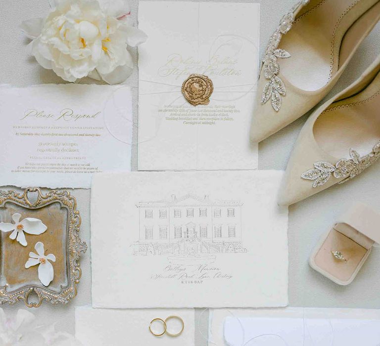 Traditional wedding stationery suite with gold wax seal and beige shoes 