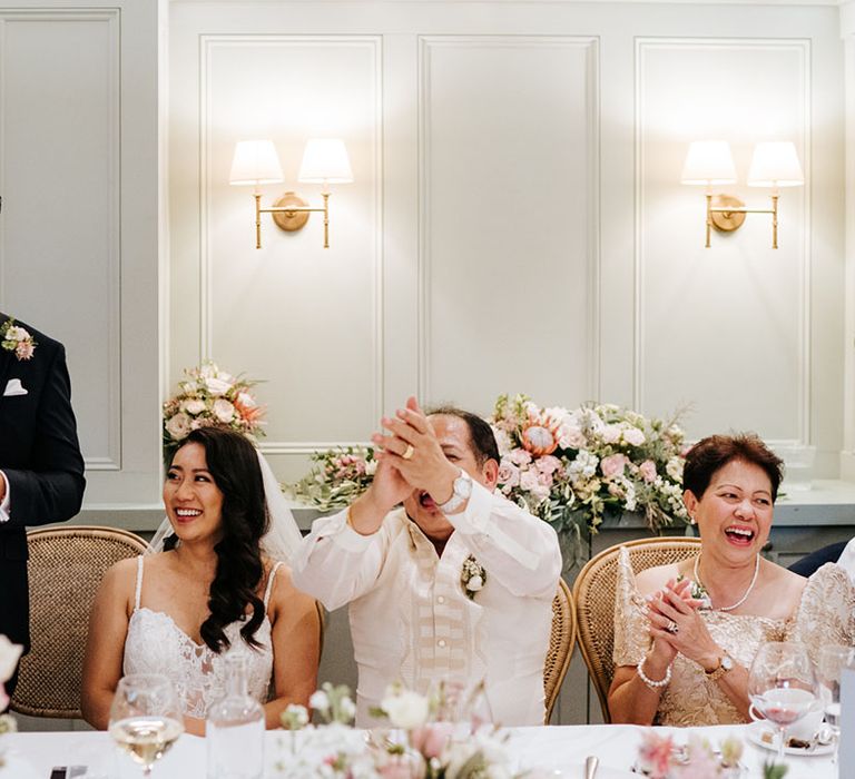 Groom in a grey waistcoat and navy suit delivering his wedding speech 