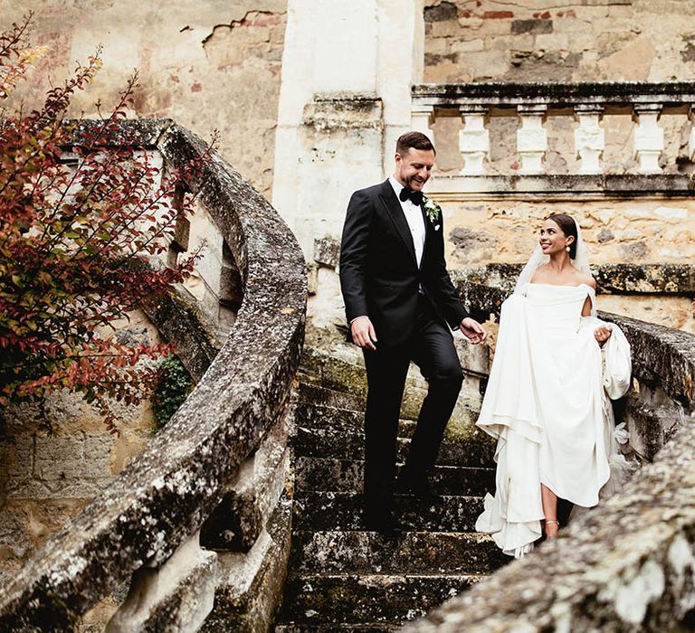 Bride & groom walk down the steps on their wedding day