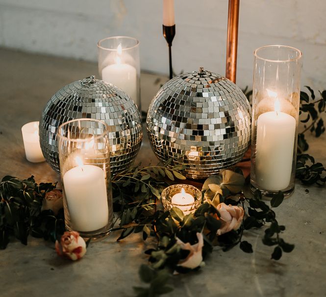 Disco ball decoration next to pillar candles