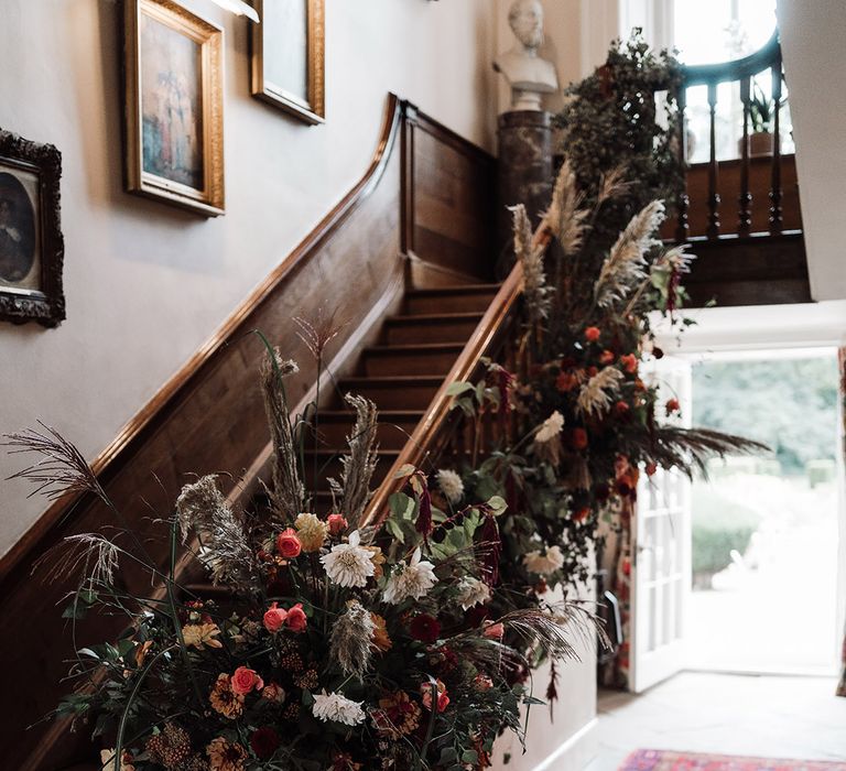 Dried and fresh staircase wedding flower arrangement at Iscoyd Park by Red Floral 