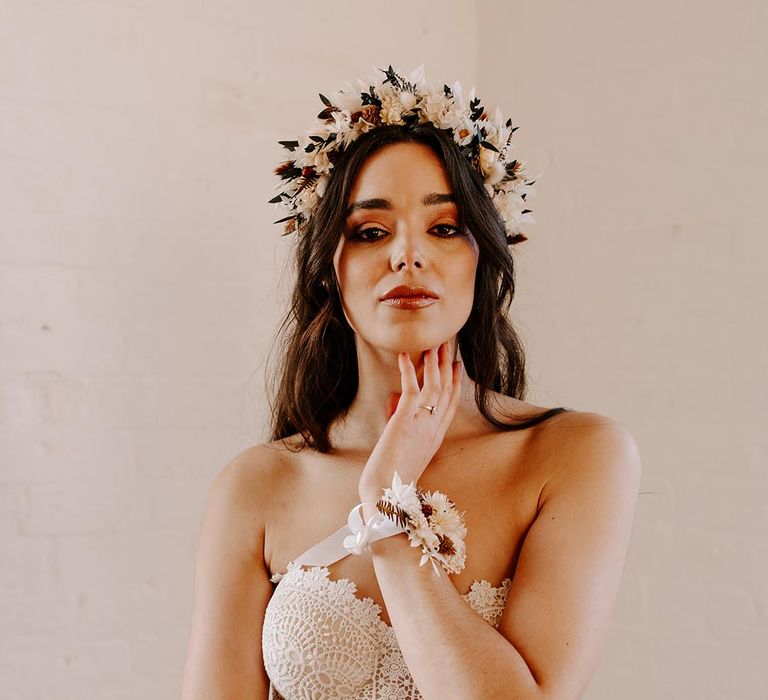 Bride in a dried flower crown and boho lace strapless wedding dress by Shikoba Bride