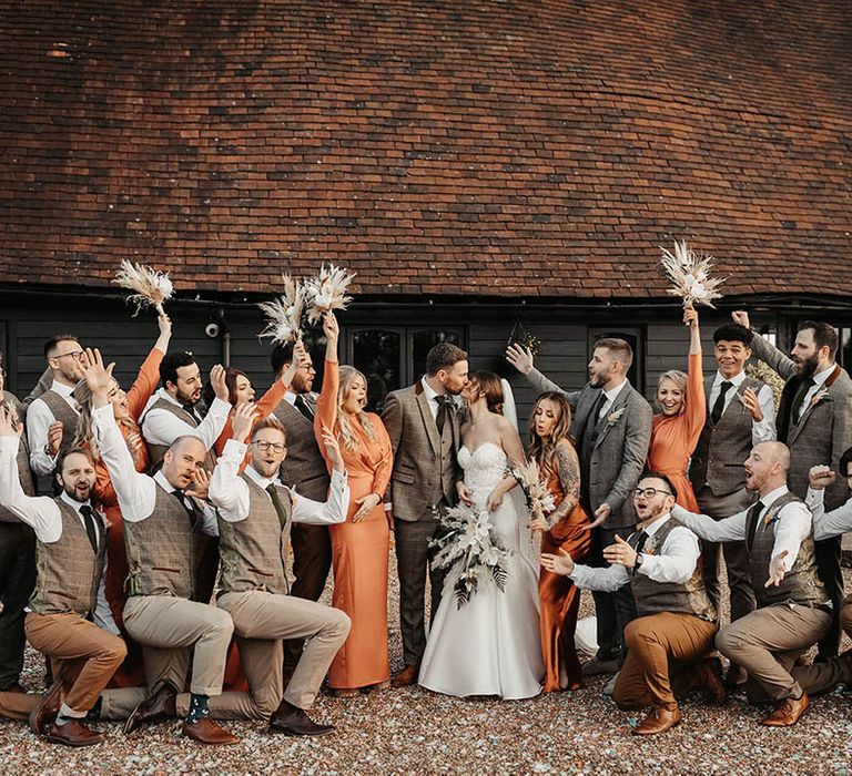 Burnt orange bridesmaid dresses and tweed wedding suits