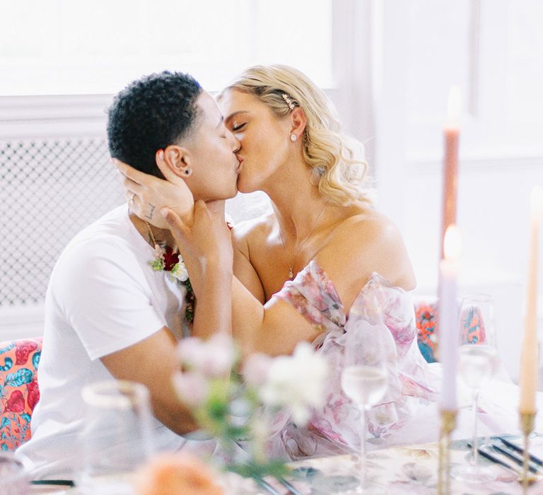 LGBTQI+ couple kissing at their floral wedding reception at Barnett Hill Hotel 