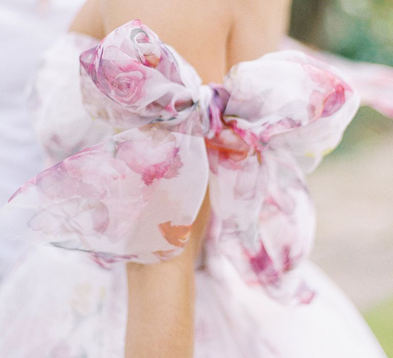 pink floral strapless wedding dress with bow detail 