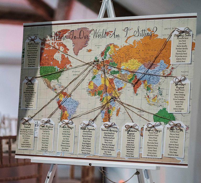 World map wedding seating chart with tables named after places important to the couple 