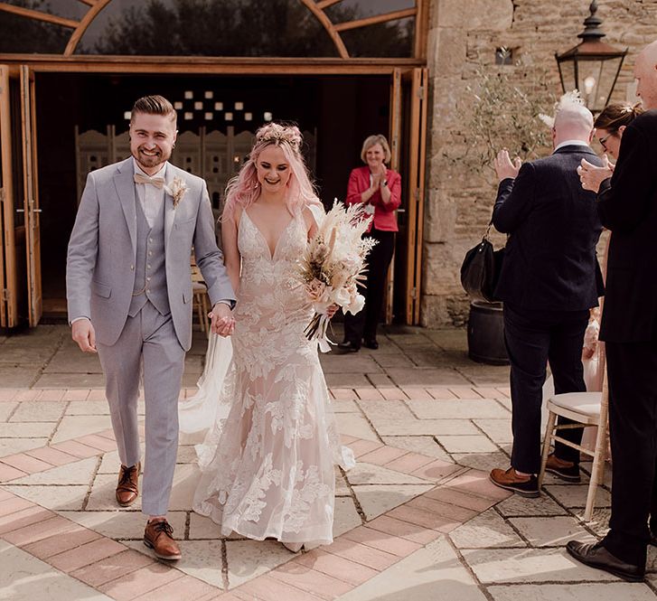 Bride & groom after outdoor wedding ceremony at Oxleaze Barn 