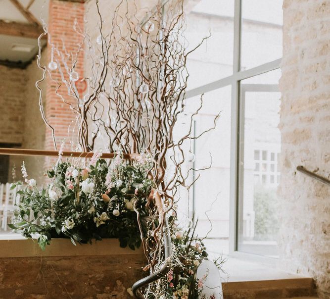 bare twigs and fresh flower wedding reception floral arrangements 