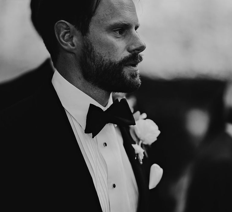 Groom in a black tie with a white rose buttonhole for classic style wedding at Callow Hall 