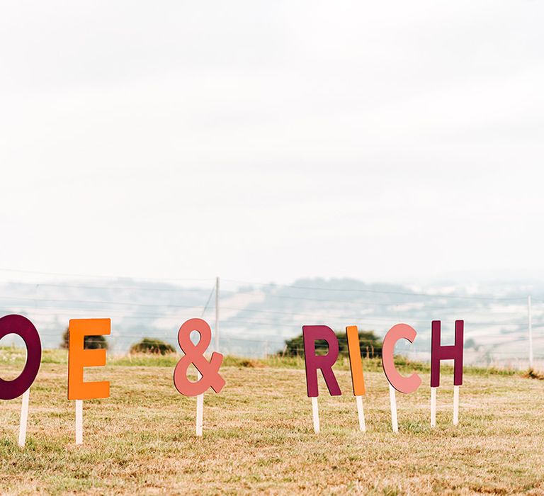 Pink, orange and burgundy coloured MDF personalised wedding sign 