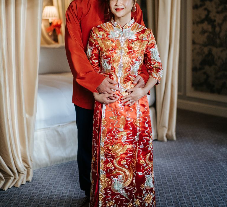 Groom embraces his bride during Chinese Tea Ceremony at The Dorchester on their wedding day