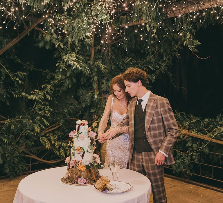 bride and groom cutting their woodland wedding cake 