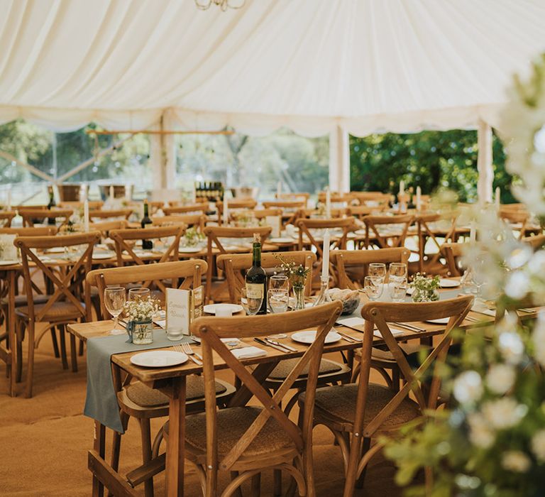 Marquee wedding reception at Badgers Holt with simple foliage decorations and blue wedding decor