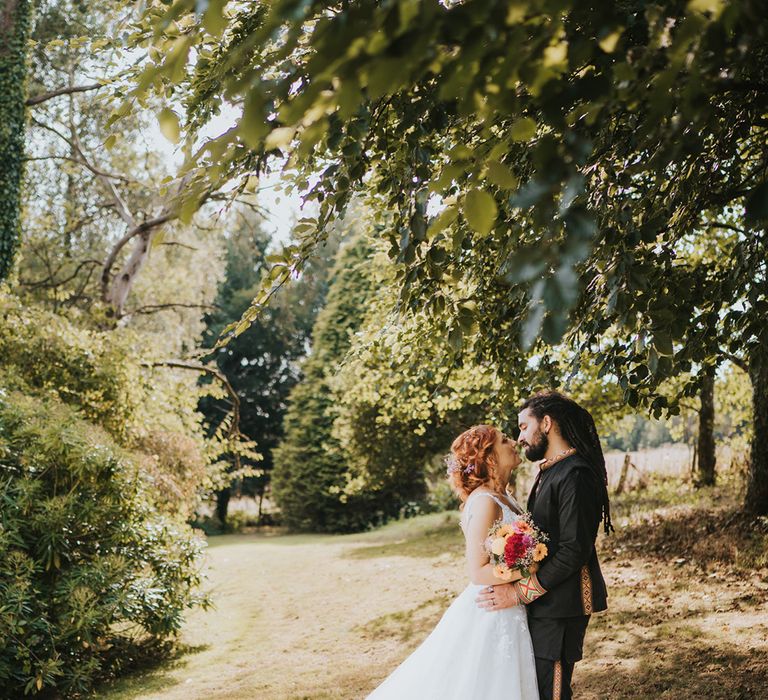 Multicultural wedding with mixed Caribbean groom and bride in a lace wedding dress