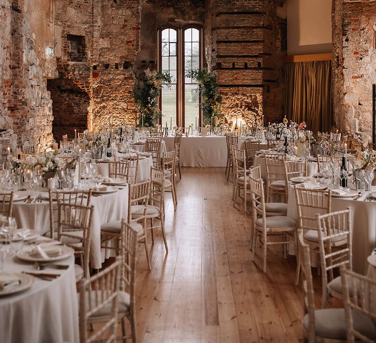 Romantic round tables with long top table for luxury castle wedding tablescape 