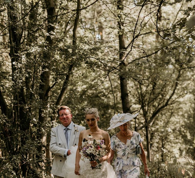 Camp Katur wedding with the bride's parents in white and blue outfits walking her down the aisle 