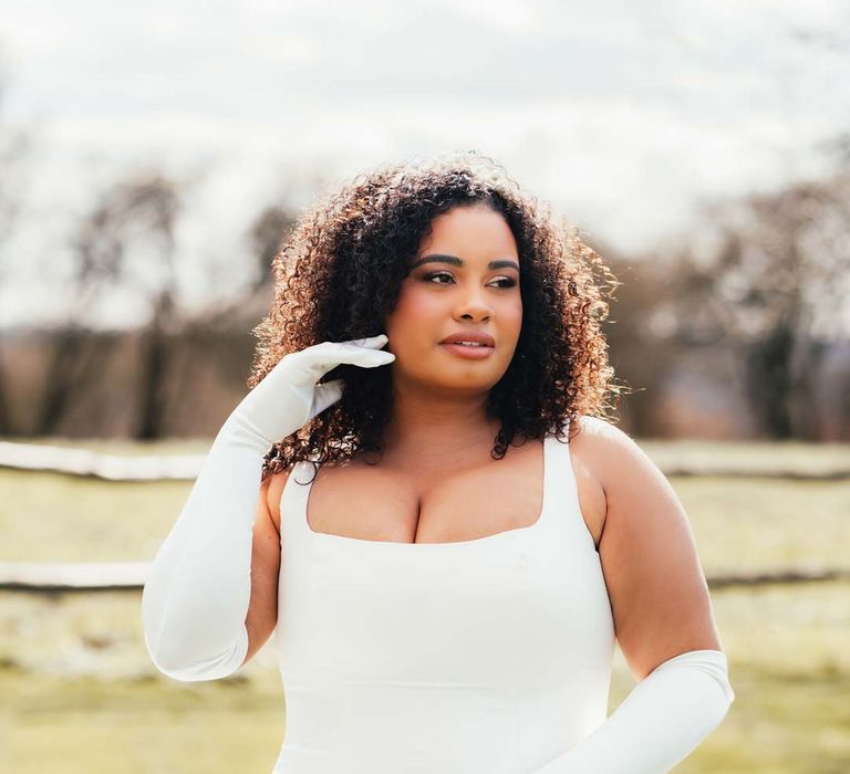 Bride in square neck satin wedding dress with long white gloves at Rackleys Barn