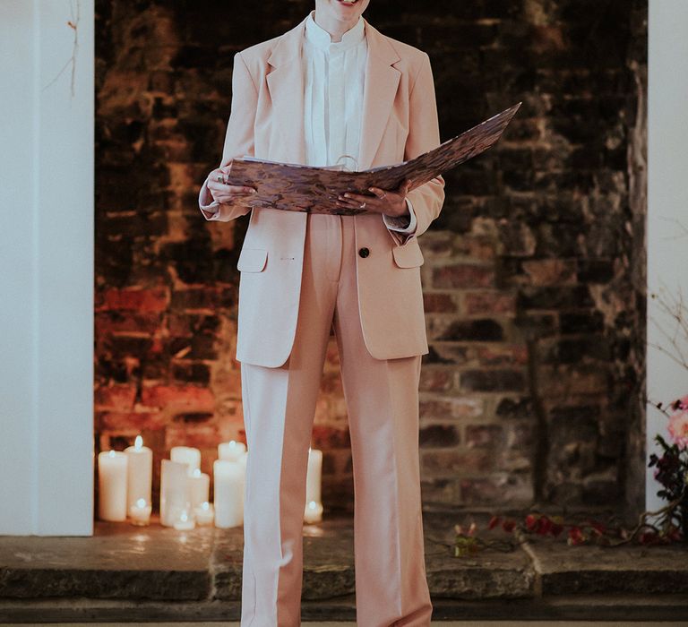 Celebrant in light pink suit at Aswarby Rectory wedding venue