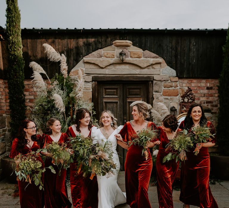 Bridal party wearing orange velvet bridesmaid dresses at the Loughborough wedding 